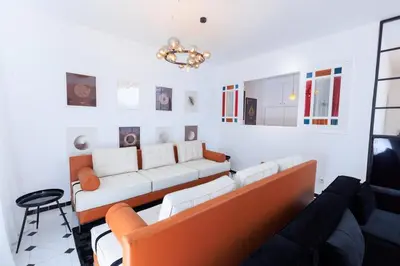 a living room with a couch and a table at Modern Elegance 2BR in the Heart of Agdal in Oulad Akkou