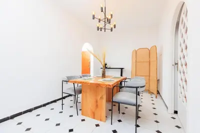 a dining room with a wooden table and chairs at Modern Elegance 2BR in the Heart of Agdal in Oulad Akkou