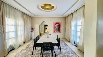 a dining room with a table and chairs at Villa Marwa 3ch private Marrakech in Marrakech
