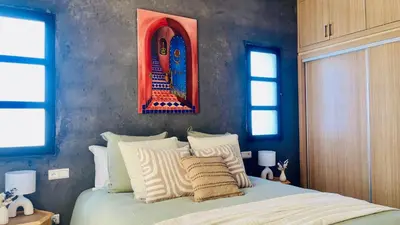 a bedroom with a bed and a picture on the wall at Villa Marwa 3ch private Marrakech in Marrakech