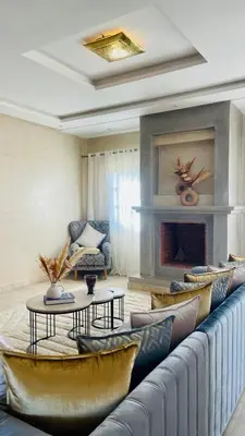 a living room with a couch and a fireplace at Villa Marwa 3ch private Marrakech in Marrakech