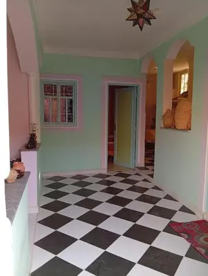 a room with a black and white checkered floor at auberge djebel rose 03 in Oulad Akkou