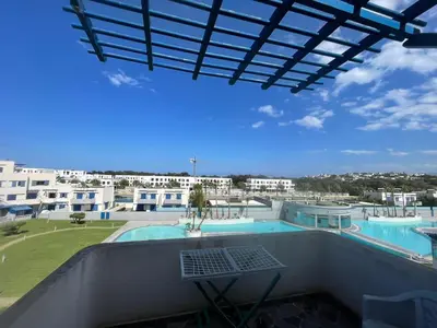 a view of a swimming pool from the balcony of a building at Modern Pool-View Luxury Flat in Oulad Akkou