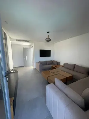 a living room with couches and a flat screen tv at Modern Pool-View Luxury Flat in Oulad Akkou