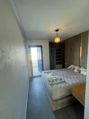 a bedroom with a large bed in a room at Modern Pool-View Luxury Flat in Oulad Akkou