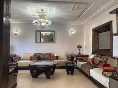 a living room with two couches and a table at Seaside Villa with Stunning View in Oulad Akkou