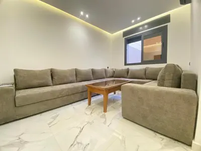 a living room with a couch and a table at Modern Equipped Central Suite terassa 8 in Oulad Akkou