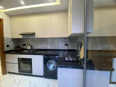 a kitchen with a washing machine and a dishwasher at Modern Equipped Central Suite terassa 8 in Oulad Akkou