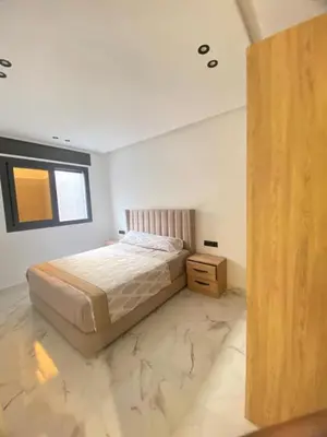 a bedroom with a bed with a marble floor at Modern Equipped Central Suite terassa 8 in Oulad Akkou