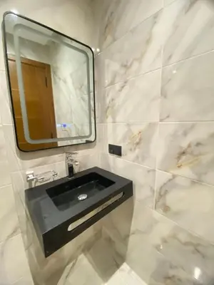 a bathroom with a black sink and a mirror at Modern Equipped Central Suite terassa 8 in Oulad Akkou