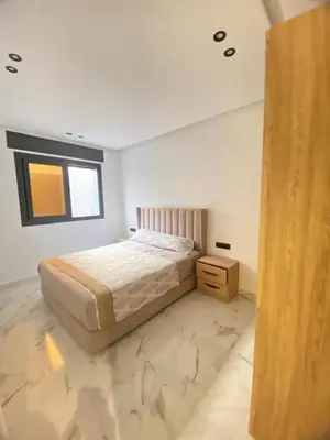 a bedroom with a bed and a dresser in it at Modern Equipped Central Suite terassa 8 in Oulad Akkou