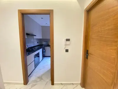 a room with a door leading to a kitchen at Modern Equipped Central Suite terassa 8 in Oulad Akkou