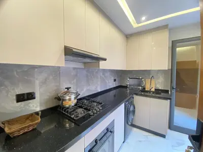 a kitchen with a stove and a counter top at Modern Equipped Central Suite terassa 8 in Oulad Akkou
