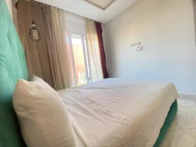 a bedroom with a white bed with a window at Modern Family Home Ful Equipped in Oulad Akkou