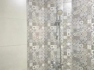 a shower in a bathroom with a tile wall at Modern Family Home Ful Equipped in Oulad Akkou