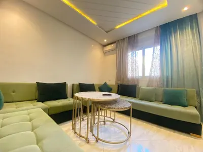 a living room with a couch and a table at Modern Family Home Ful Equipped in Oulad Akkou