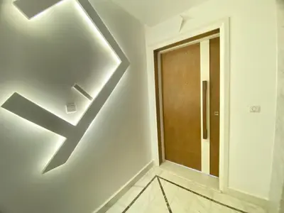 a hallway with a door with a arrow on the wall at Modern Family Home Ful Equipped in Oulad Akkou
