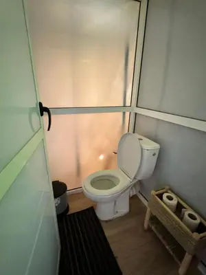 a small bathroom with a toilet in a stall at sunshine luxury camp in Merzouga
