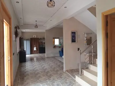 a hallway with a staircase in a house at charmante villa à découvrir in Aghmat