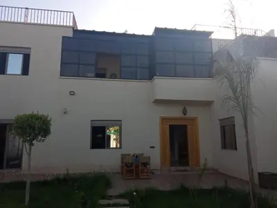 a large white house with a large window at charmante villa à découvrir in Aghmat