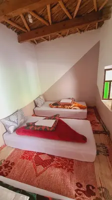 a room with three beds in a room at Gîte Jamal taghia in Taghia