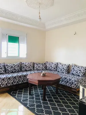 a living room with a couch and a table at Stay 5 minutes from Fes airport in Oulad Tayeb
