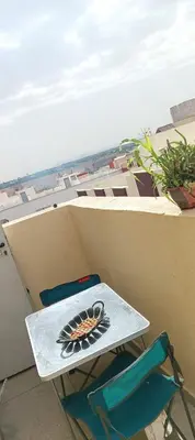 a table and two chairs on a balcony at Stay 5 minutes from Fes airport in Oulad Tayeb