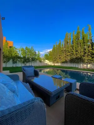 a patio with a table and chairs and a pool at luxury villa ourika in Oulad Akkou