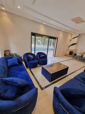 a living room with blue couches and a coffee table at luxury villa ourika in Oulad Akkou