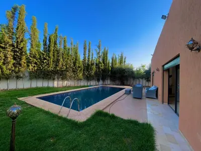 a swimming pool in a yard next to a building at luxury villa ourika in Oulad Akkou