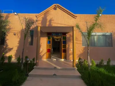 a building with a colorful door in front of it at luxury villa ourika in Oulad Akkou