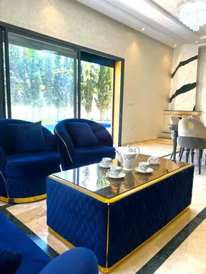 a living room with blue couches and a coffee table at luxury villa ourika in Oulad Akkou