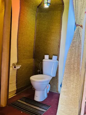 a bathroom with a toilet in a room at Sunlight Luxury Desert Camp in Merzouga