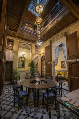 a large room with a table and chairs at Saphiryad in Fès