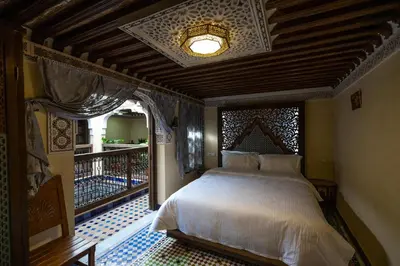 a bedroom with a bed in a room with a window at Saphiryad in Fès