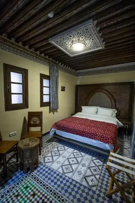 a bedroom with a large bed in a room at Saphiryad in Fès