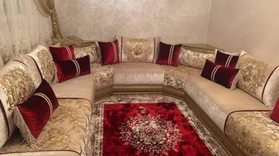 a living room with a couch with red pillows at JMEL B&b