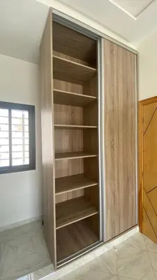 a closet with wooden shelves in a room at Near University Balcony in Fès