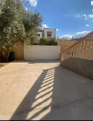 a shadow of a fence on a driveway at Villa avec piscine-Meknès in Oulad Akkou