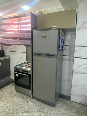 a refrigerator in a kitchen next to a stove at Villa avec piscine-Meknès in Oulad Akkou