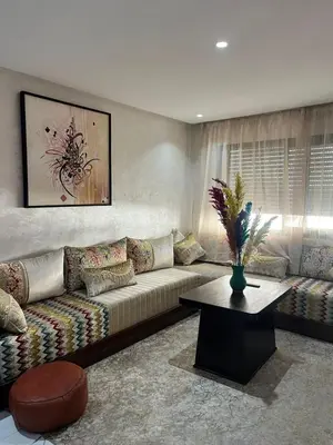 a living room with a couch and a table at cosy studio au coeur de casablanca in Oulad Akkou