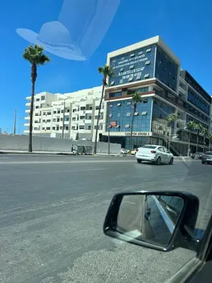 a side view mirror of a car in front of a building at cosy studio au coeur de casablanca in Oulad Akkou