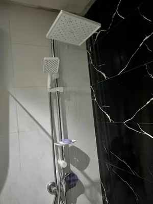 a shower with a shower head in a bathroom at cosy studio au coeur de casablanca in Oulad Akkou