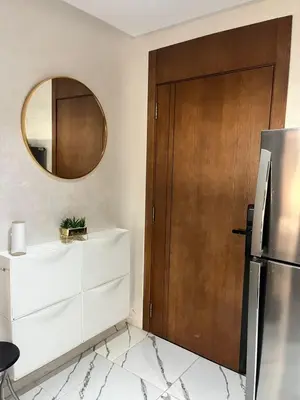 a kitchen with a refrigerator and a mirror at cosy studio au coeur de casablanca in Oulad Akkou