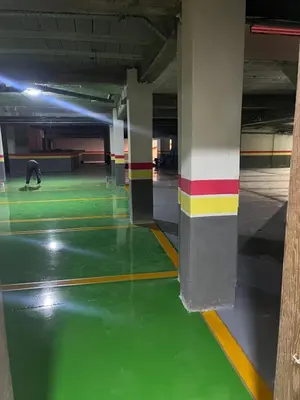 an empty parking garage with green paint on the floor at cosy studio au coeur de casablanca in Oulad Akkou