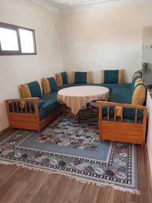 a living room with a couch and a table at Appartement massira in Beni Mellal