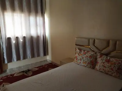 a bedroom with a bed with a window at Appartement massira in Beni Mellal