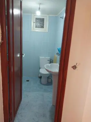 a bathroom with a toilet and a sink at Appartement massira in Beni Mellal