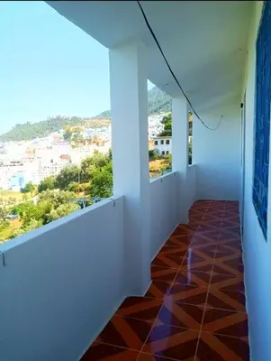 an empty room with white walls and a tile floor at Dar Hayoun in Oulad Akkou