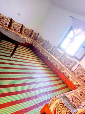 a room with a colorful carpet and a window at Dar Hayoun in Oulad Akkou